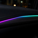 Close-up of RGB fiber optic light strip glowing purple to teal in a car door